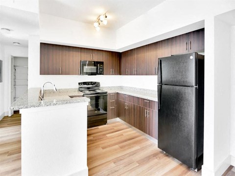 a kitchen with stainless steel appliances and wooden cabinets