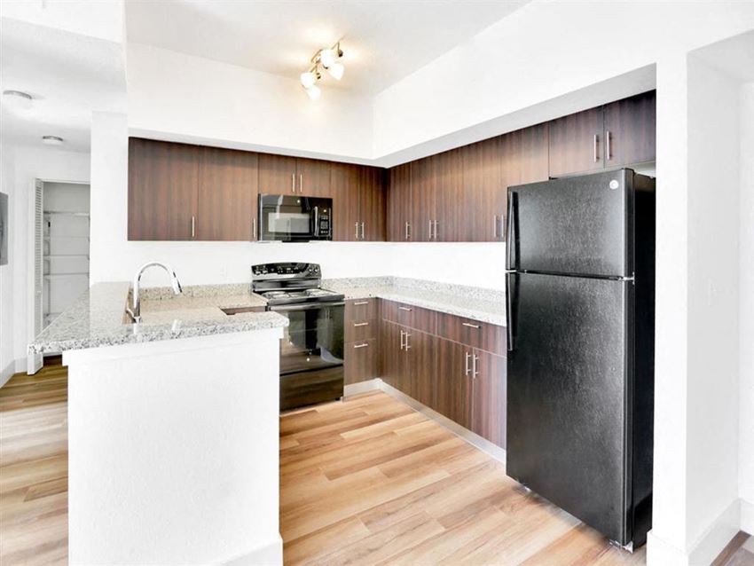 a kitchen with stainless steel appliances and wooden cabinets