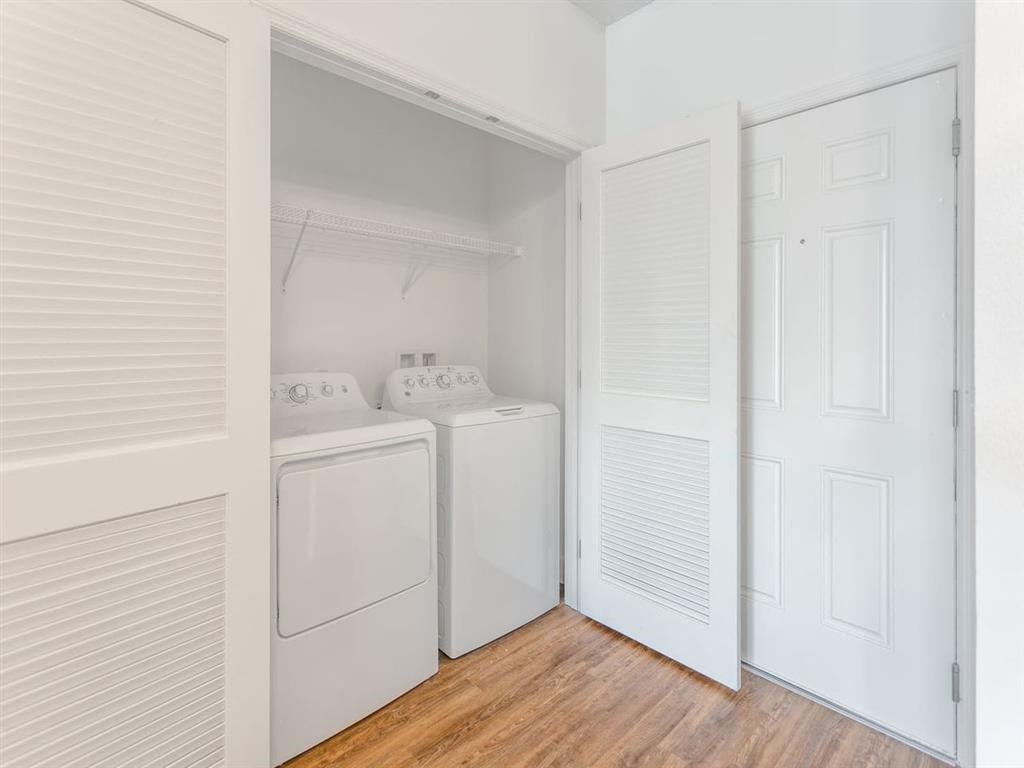 a laundry room with a washer and dryer and white doors