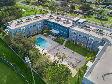 an aerial view of a building with a swimming pool
