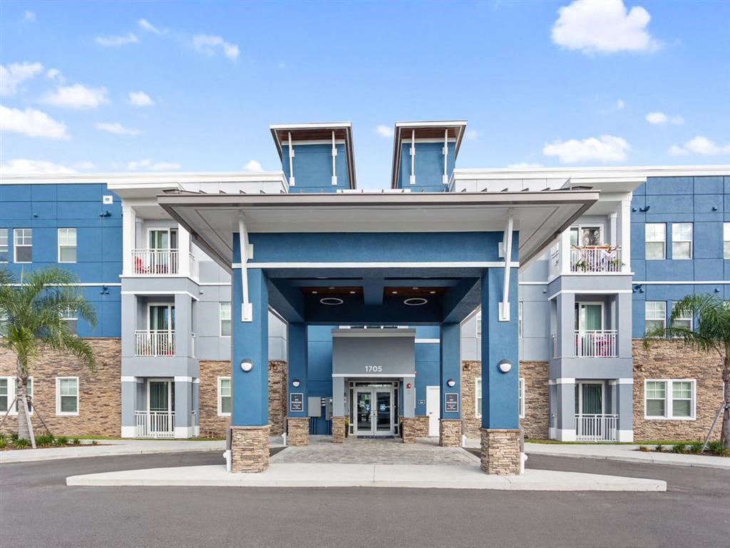 a large building with blue pillars and a blue sky