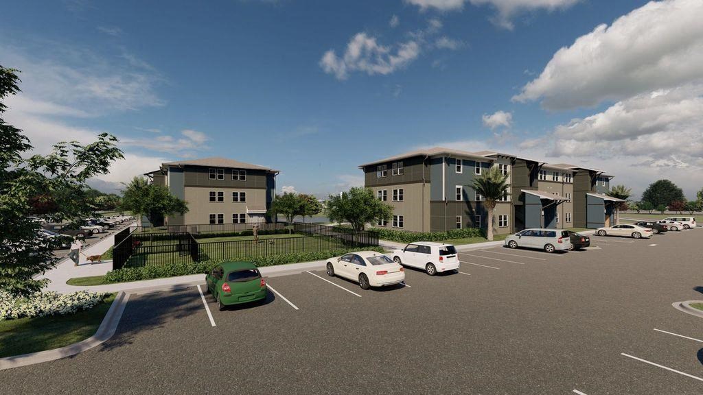 a parking lot with cars in front of some buildings