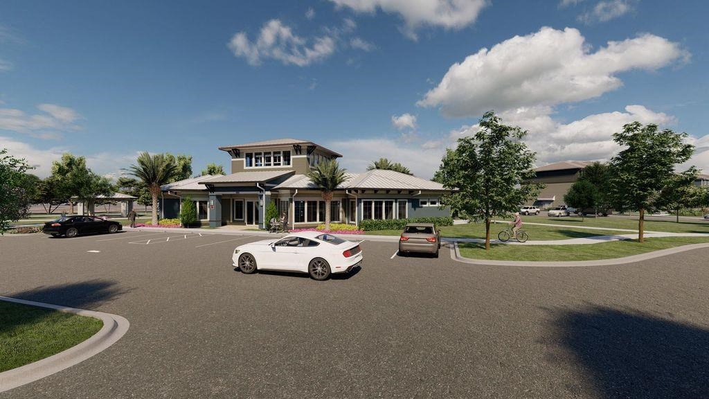 a white car driving down a street in front of a building