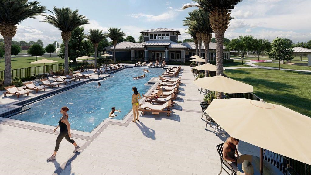 people are walking around the pool at a resort