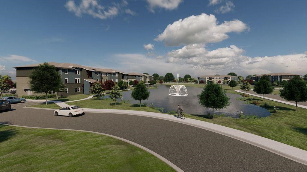 an aerial view of a pond with a fountain