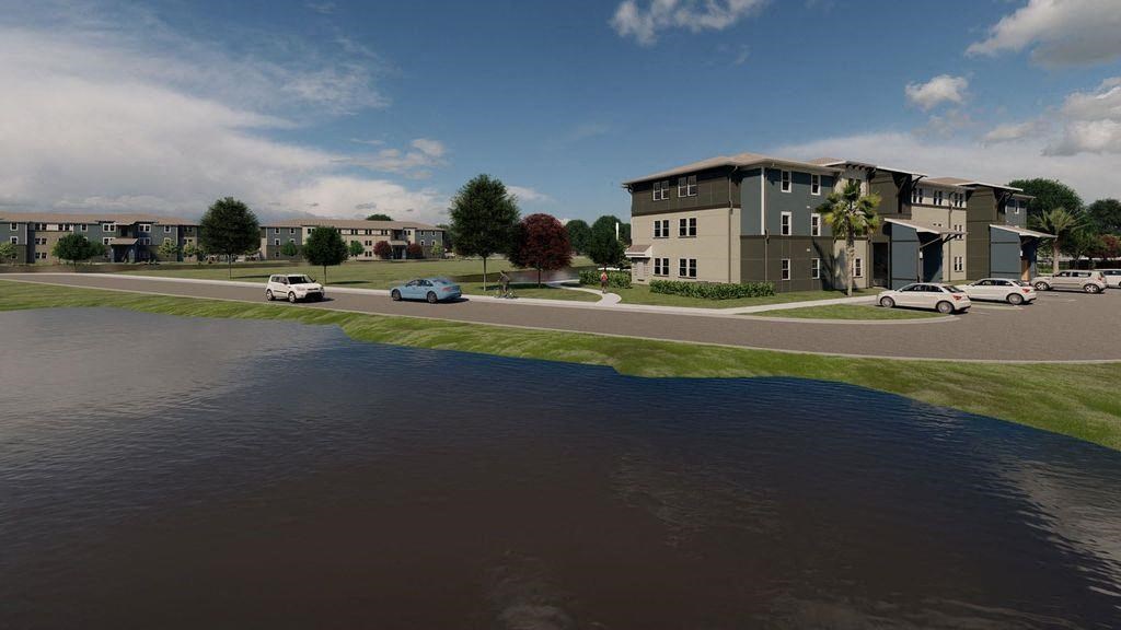 an aerial view of an apartment building near a body of water