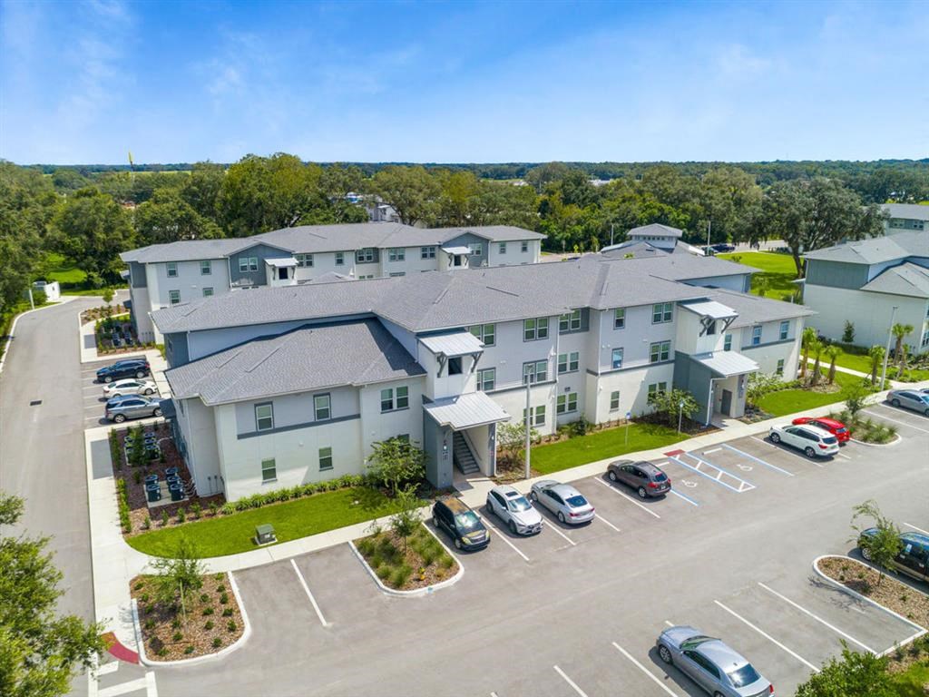 a large building with cars parked in a parking lot