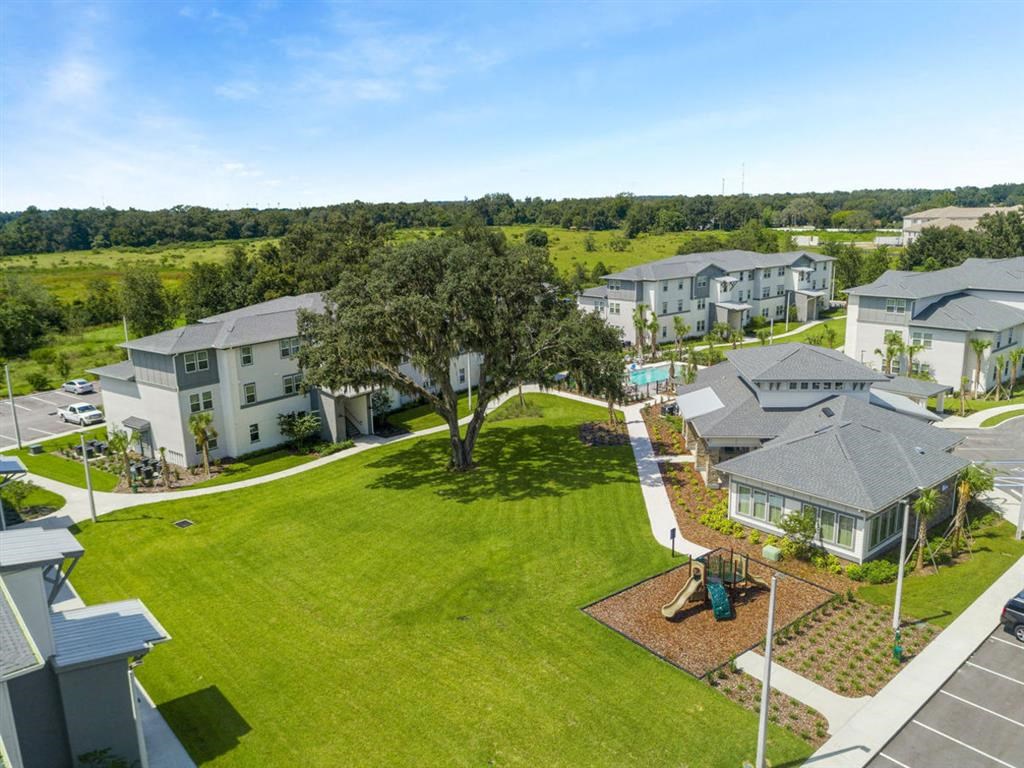 an aerial view of a neighborhood with houses and a lawn