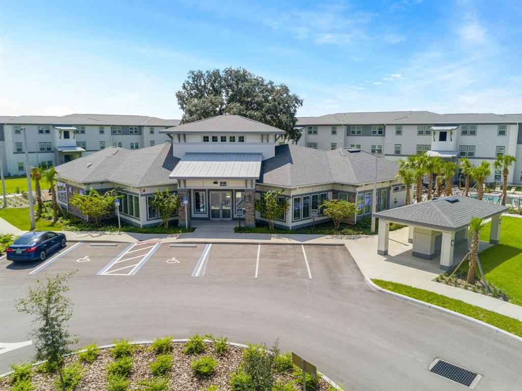 an aerial view of an apartment building with parking lot