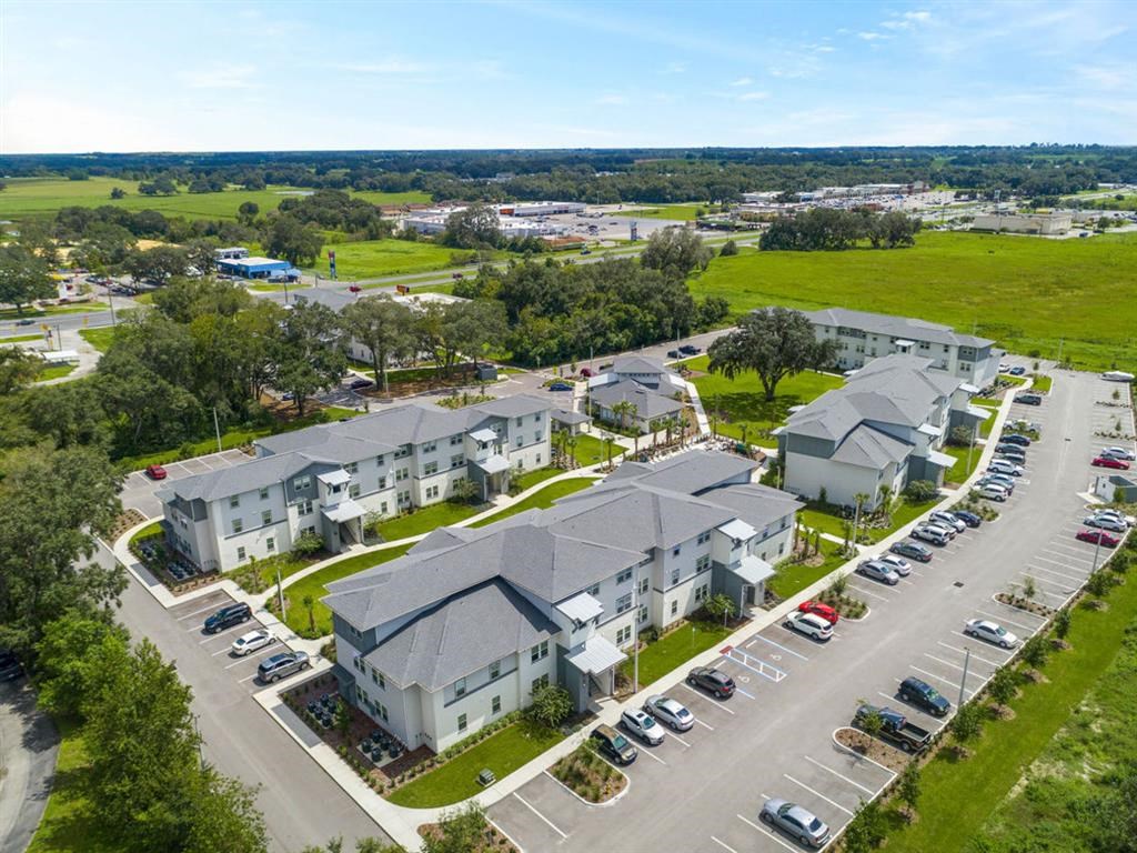 an aerial view of a group of houses in a parking lot