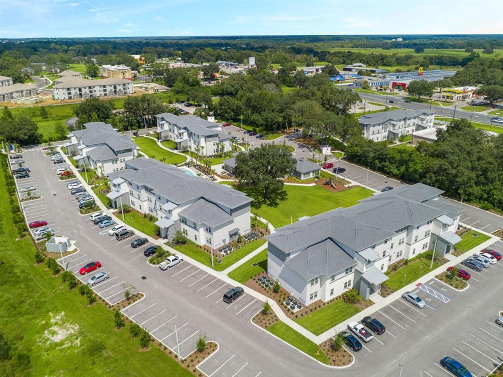 an aerial view of a group of houses in a parking lot