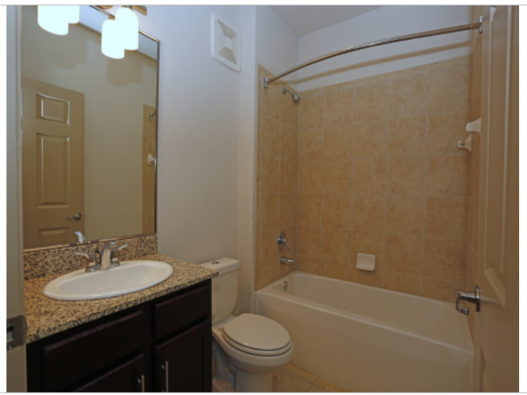 a bathroom with a sink toilet and a bath tub