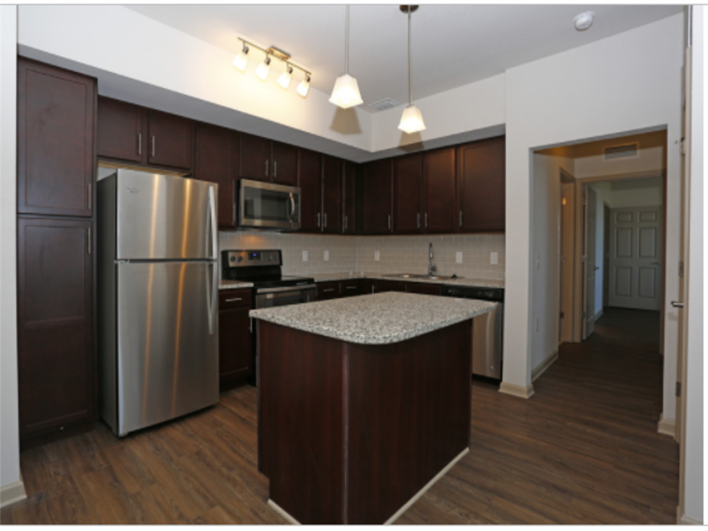 a kitchen with stainless steel appliances and granite counter tops