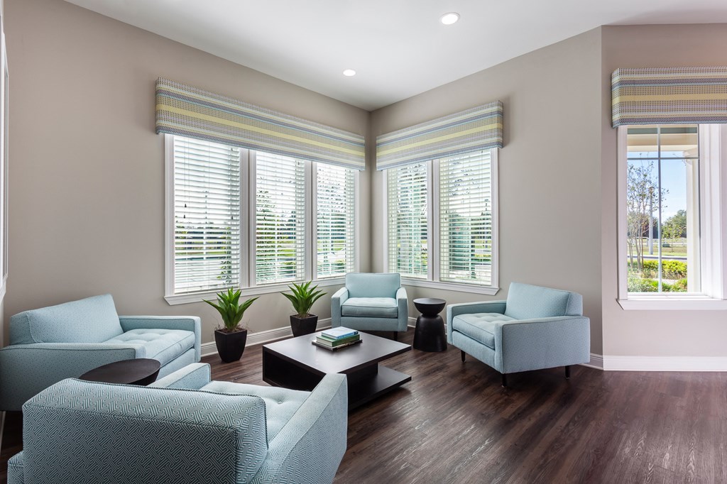 a living room with blue couches and chairs