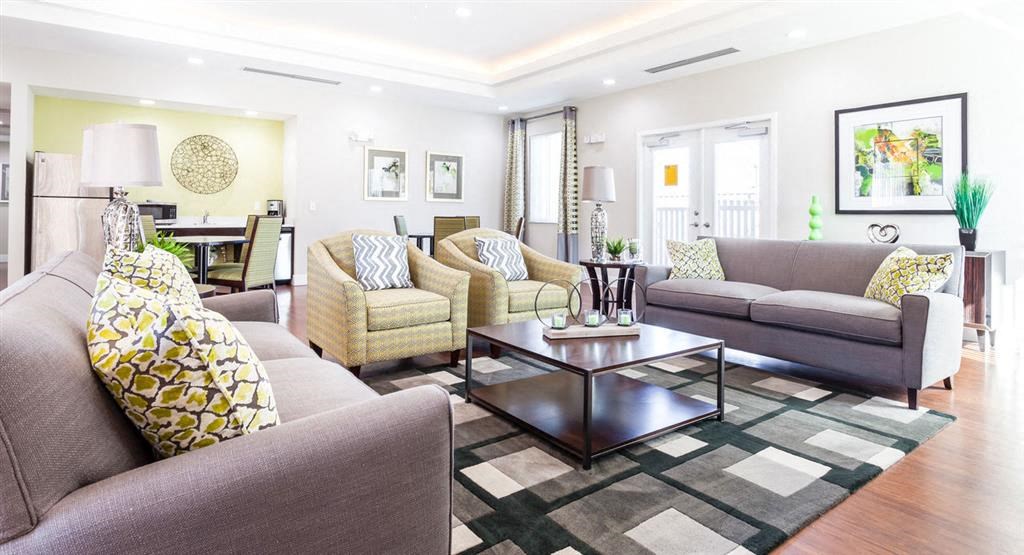 a living room with couches and chairs and a table