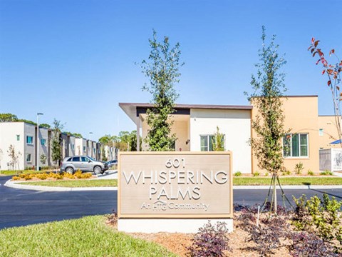 a sign in front of an apartment building