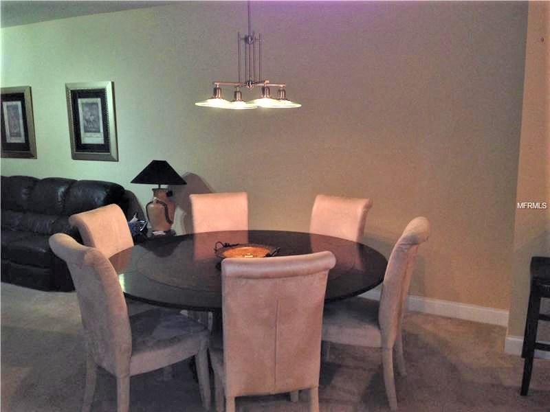 a dining room with a table and chairs
