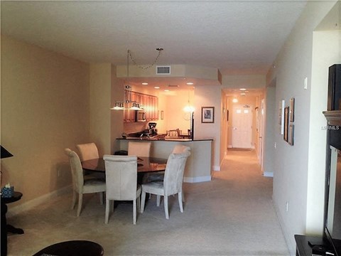 a dining room and kitchen with a table and chairs