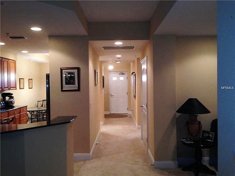 a long hallway with a white door in the middle