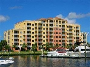 a large apartment building overlooking a harbor with boats