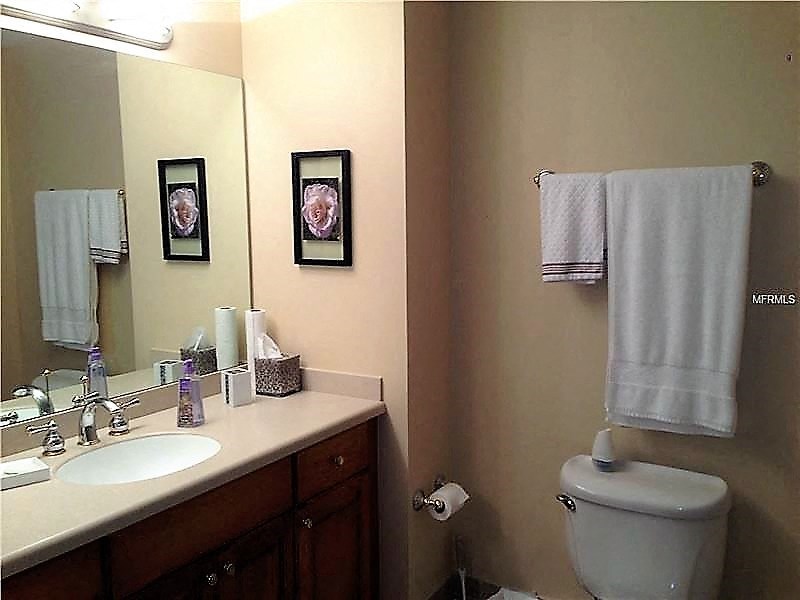 a bathroom with a toilet and a sink and a mirror