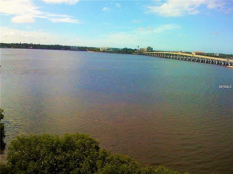 a large body of water with a bridge over it