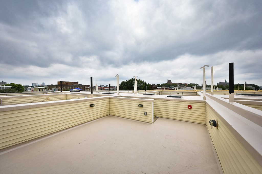 the roof of a building with a cloudy sky in the background