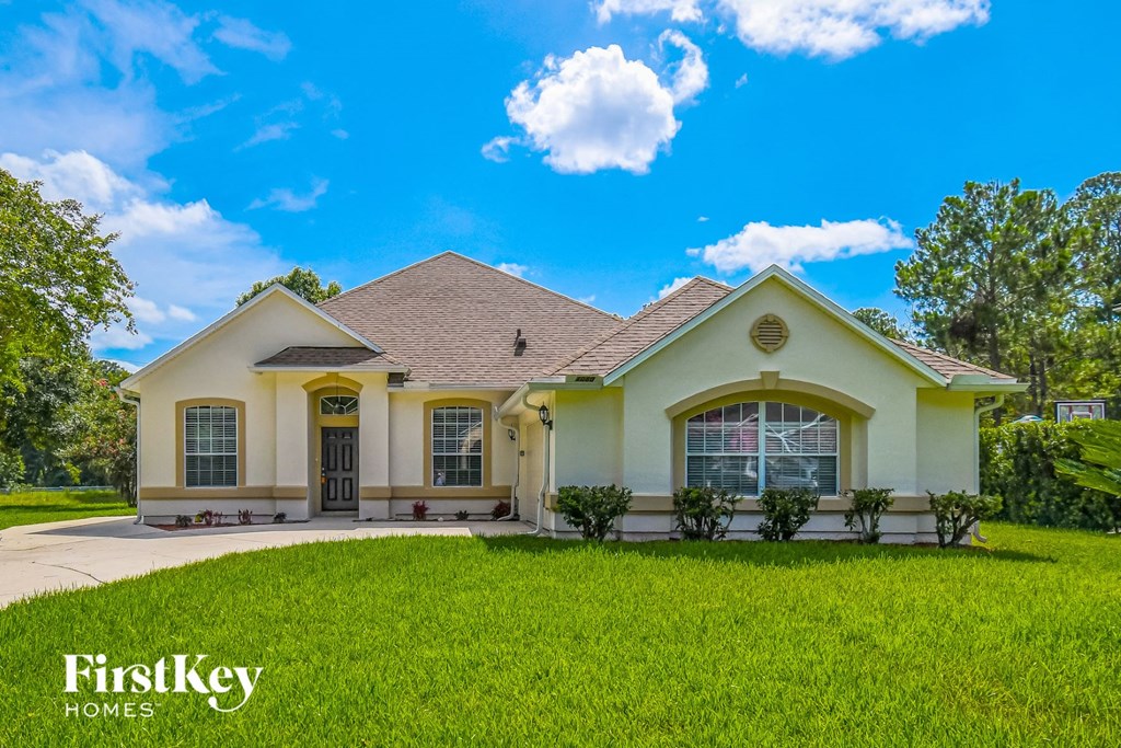 a house with a lawn and a blue sky