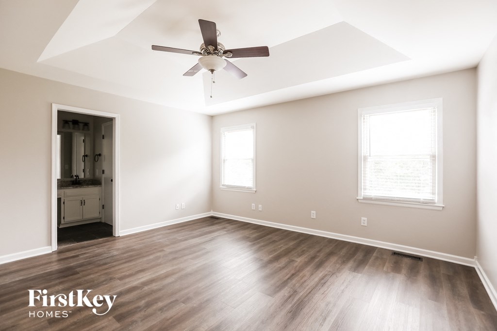 a living room with hardwood floors and a ceiling fan