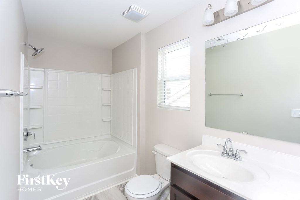 a bathroom with a sink and a toilet and a bath tub
