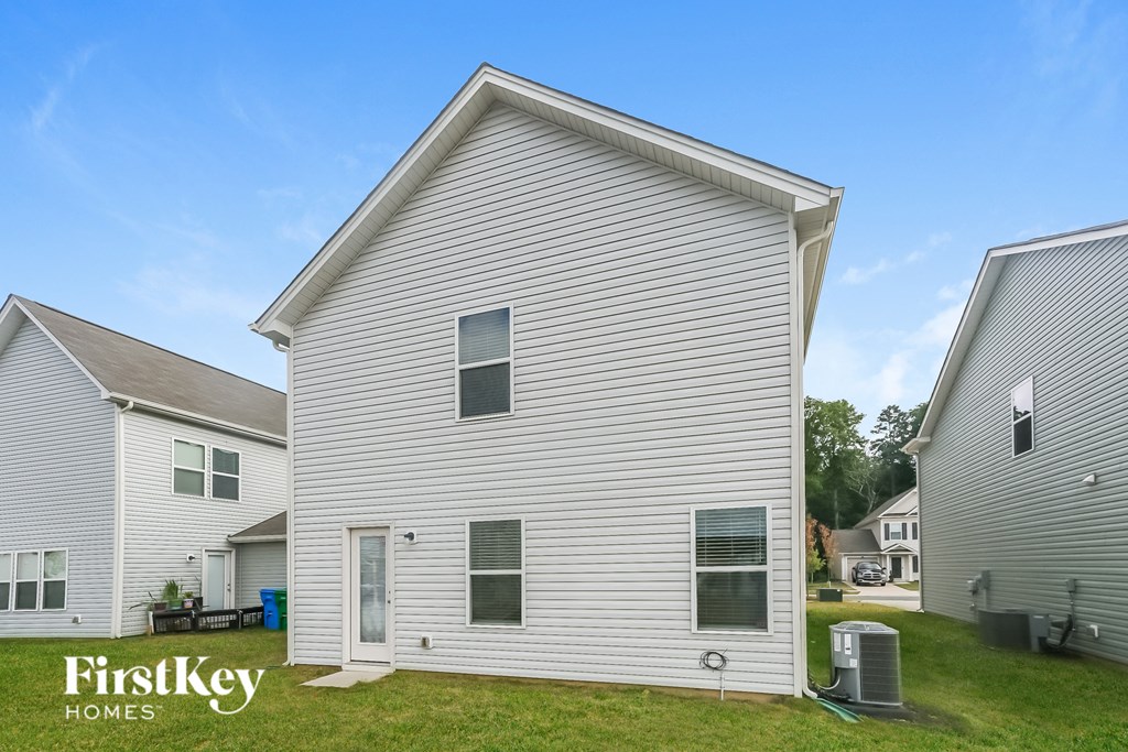 a white house with white siding and a grassy yard