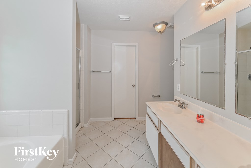 a bathroom with a sink and a mirror and a shower