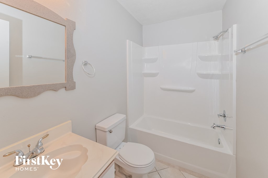 a bathroom with a shower and a sink and a toilet