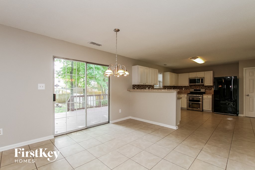 an empty kitchen with a sliding glass door to the patio