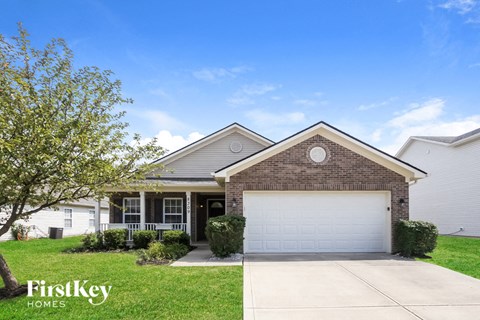 a home with a white garage door in front of it