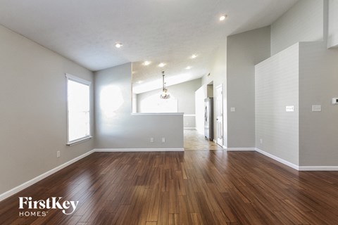 the living room and dining room with hardwood flooring