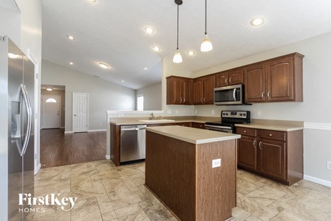 a kitchen with wooden cabinets and stainless steel appliances