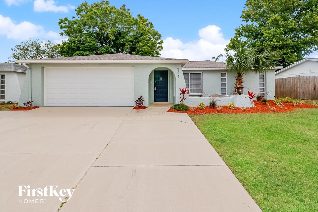 A house with a driveway in front of it.