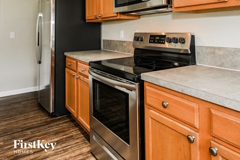 a kitchen with stainless steel appliances and wooden cabinets