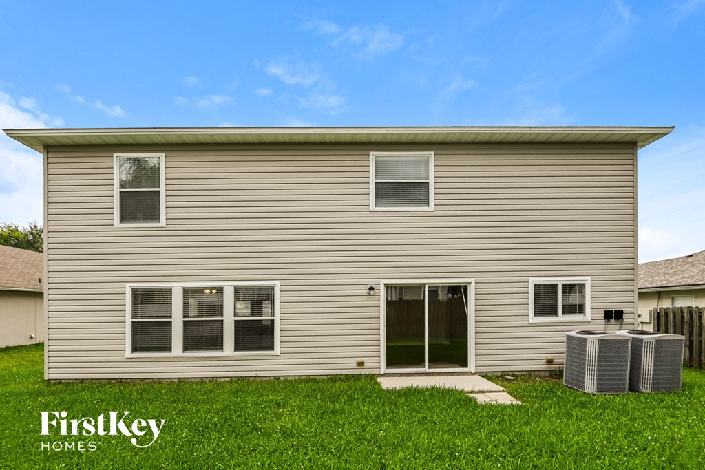 the outside of a house with a yard and grass