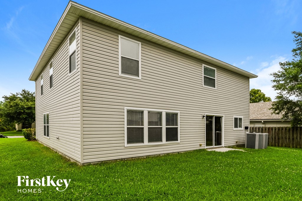 the outside of a house with a yard and grass