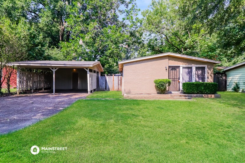 a small house with a yard and a garage