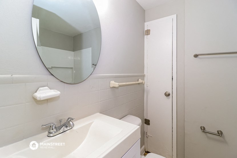 a bathroom with a sink and a mirror and a shower