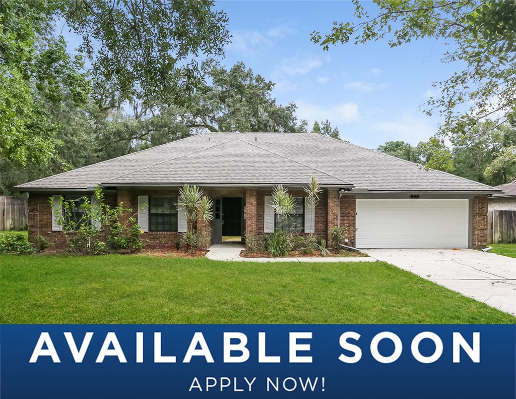 a suburban home with a lawn and a driveway