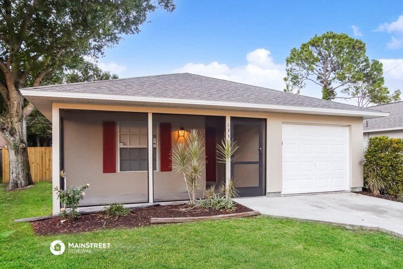 the front of a house with a driveway and a garage door