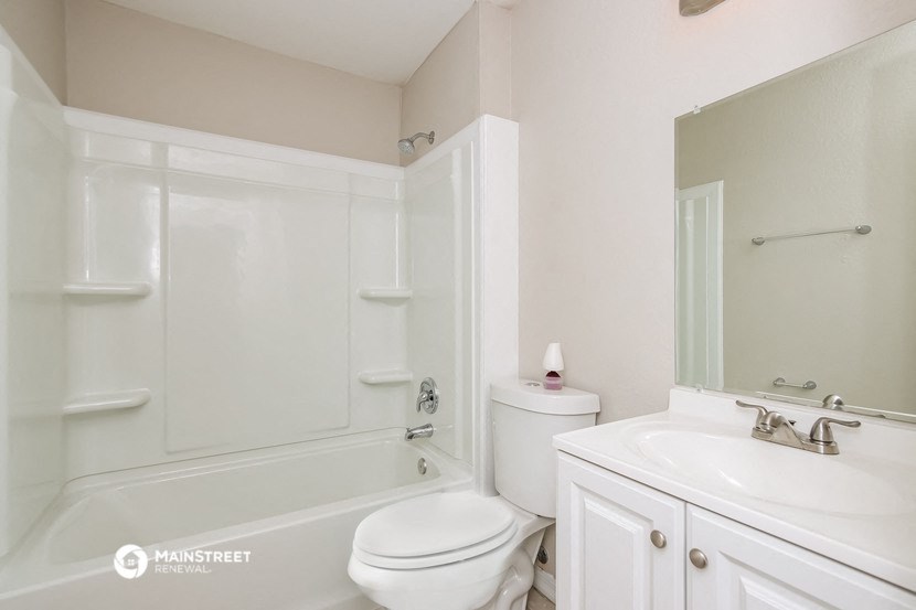 a bathroom with a sink toilet and a bath tub