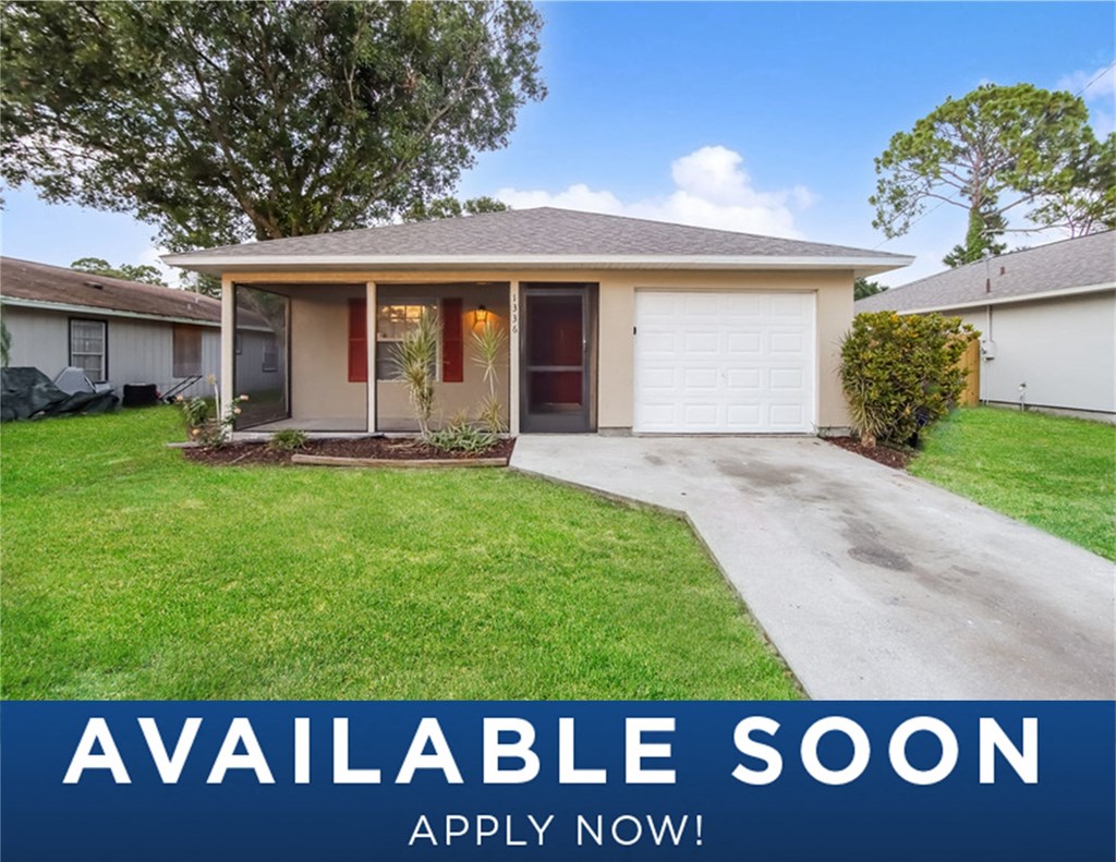 a small house with a lawn and a driveway