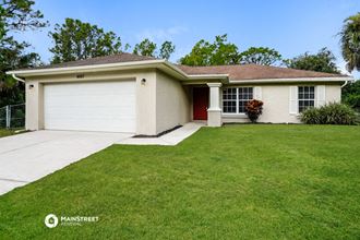 a white house with a lawn and a white garage door