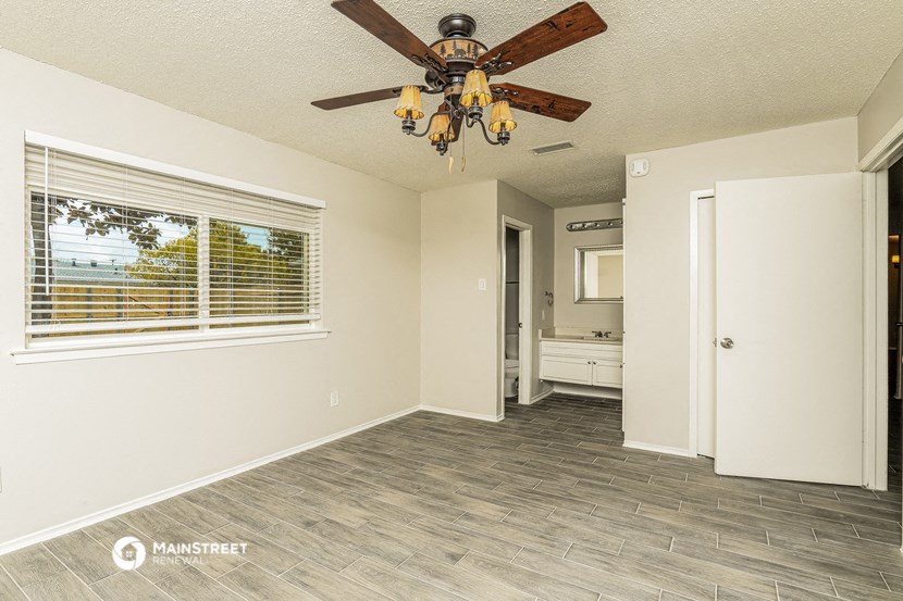 a living room with a ceiling fan and a window