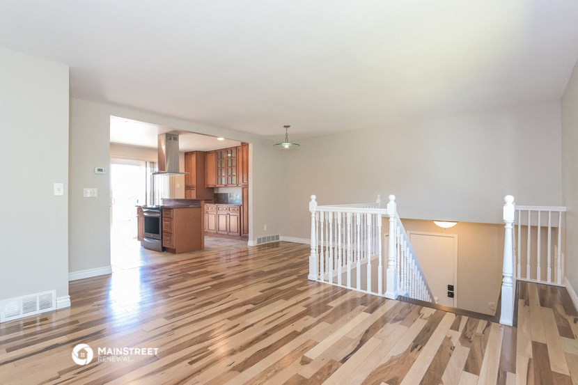 the living room and kitchen of an empty house